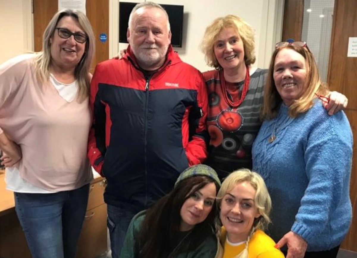6 members of the New Script for Mental Health campaign pose in an office - 4 standing at the back with two (including the author) kneeling together in front.